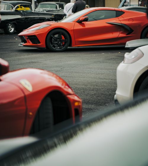 Free Red sports car showcased at an outdoor auto event, highlighting luxury and design. Stock Photo