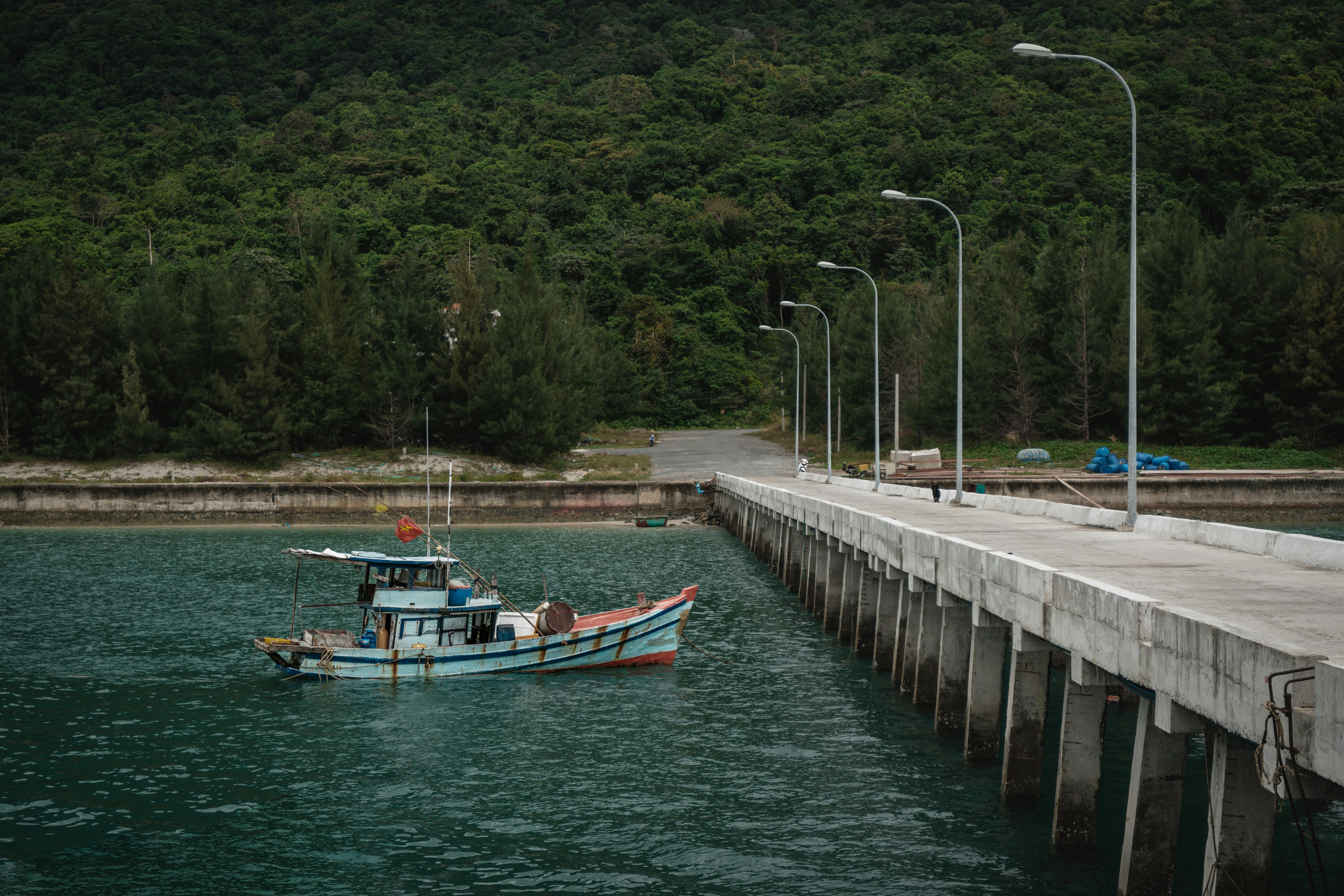 Free A serene view of a fishing boat docked in Ba Ria - Vung Tau, Vietnam. Stock Photo