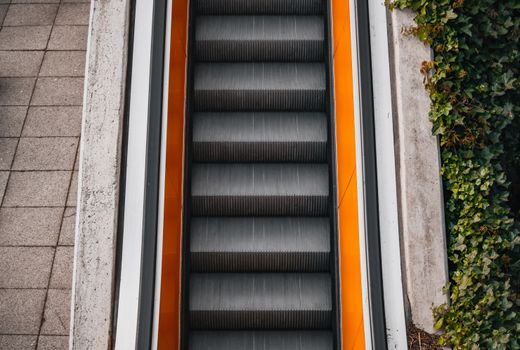 Top view of an escalator surrounded by urban and natural elements in Hamburg, Germany.