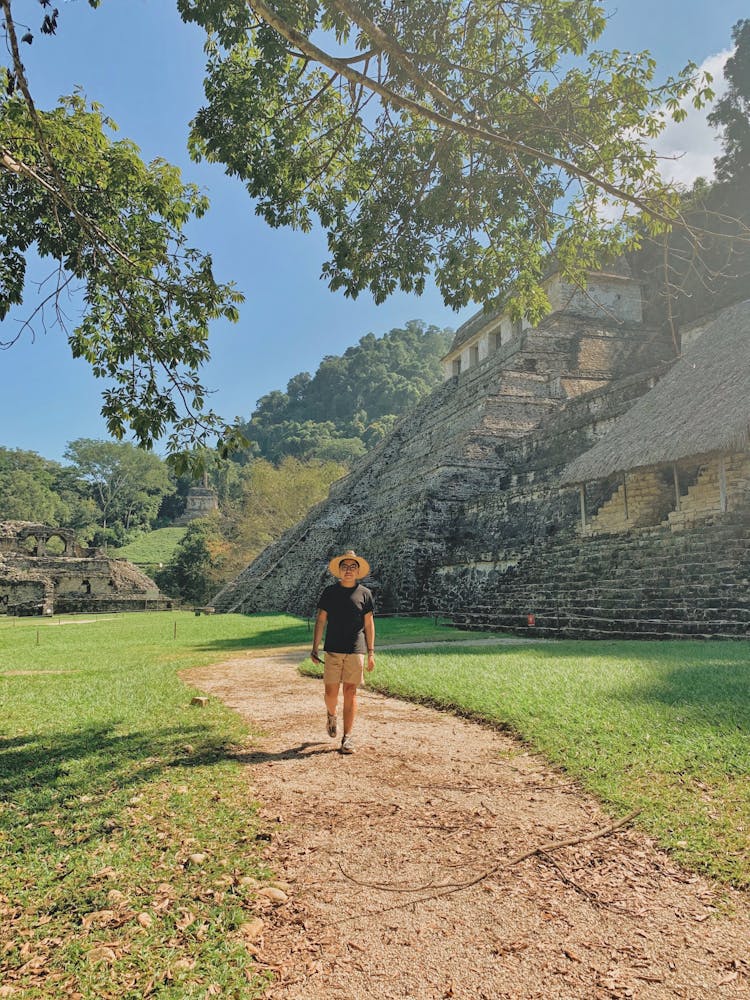 Man Walking Down A Pathway In The Palenque, Chiapas, Mexico