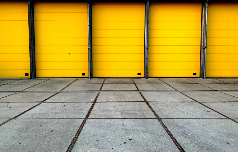 Bold yellow garage doors in an urban landscape showcasing symmetry and geometric design.