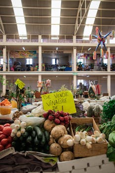 Colorful market stall in Morelia, Mexico, showcasing fresh vegetables and traditional decorations.