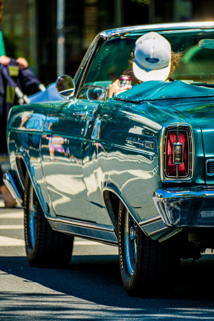 Back View Of A Person Driving A Convertible Car