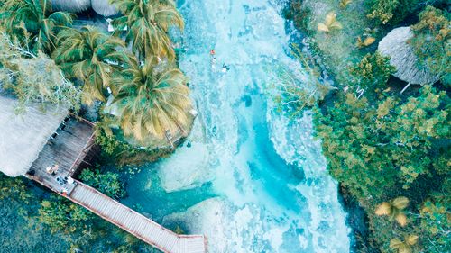 Free Stunning aerial shot of a tropical paradise featuring lush greenery and turquoise waters. Stock Photo