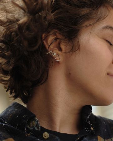 Woman wearing multiple earrings and jewellery