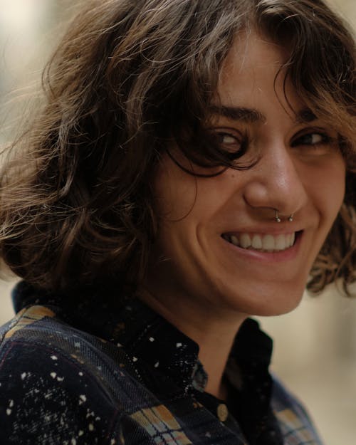 Close-up Portrait of a Woman with a Nose Piercing Smiling