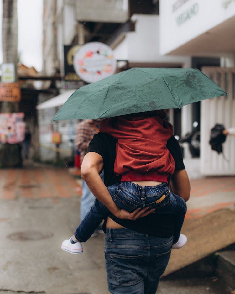 Parent Carrying Child Piggyback 