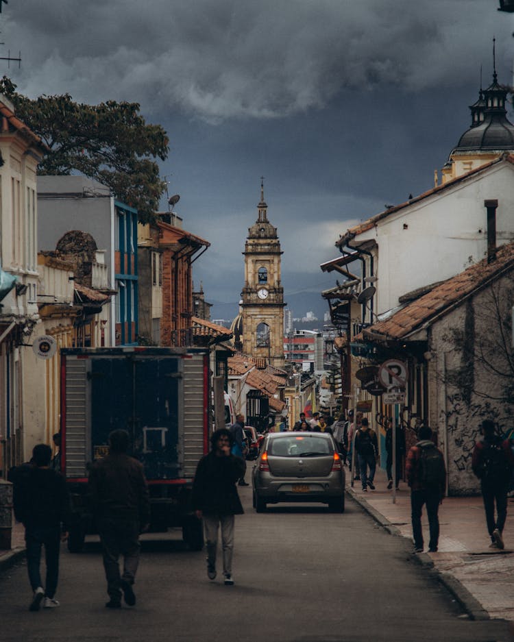 People Walking Old Town Street On Cloudy Weather