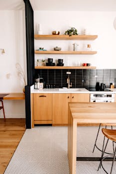 Sleek modern kitchen with minimalist wood elements and open shelving.