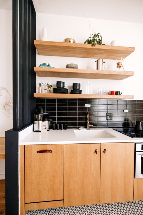 Free Stylish kitchen interior featuring wooden cabinets and open shelves. Stock Photo