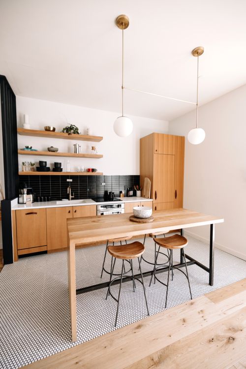 Free Bright minimalist kitchen with wooden furnishings and modern decor. Stock Photo