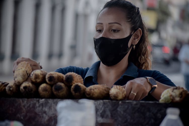 A Woman Grilling Corns