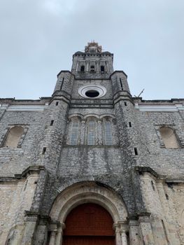 Stone facade of Iglesia de San Francisco de Asis, a landmark in Cuetzalan, Mexico.