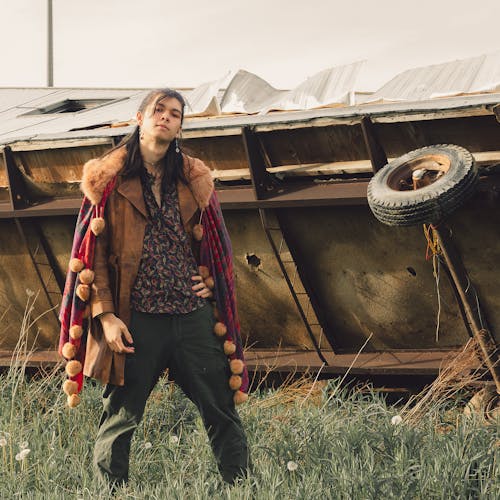 Free Man Posing in Vintage Clothes by Trailer Overturned  Stock Photo