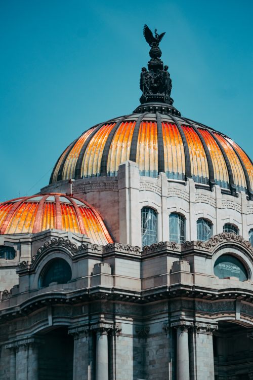 Free Brightly colored dome of the Palacio de Bellas Artes in Mexico City against a clear blue sky. Stock Photo
