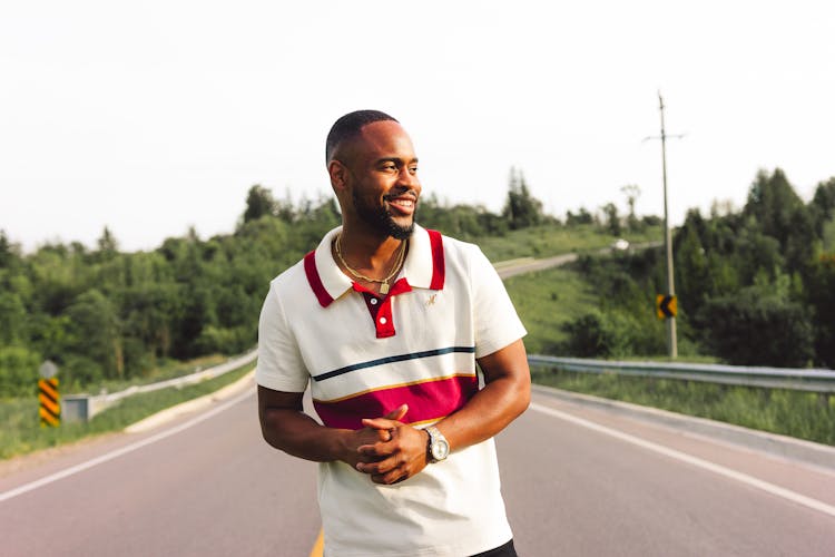 Shot Of A Man In Sport T-Shirt Walking On Road