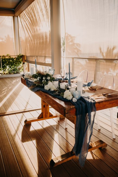 Free Beautifully arranged sunlit dining table with elegant decor. Stock Photo