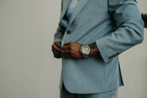 A Person Buttoning his Suit Jacket