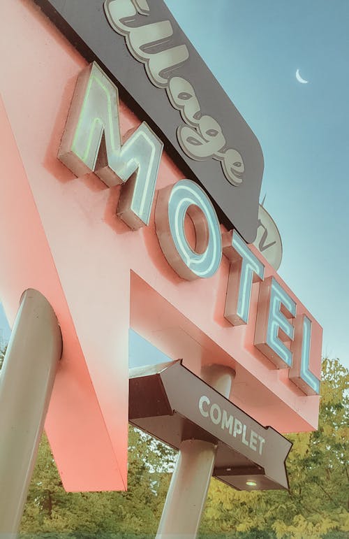 Pink and White Text Signage Under the Blue Sky