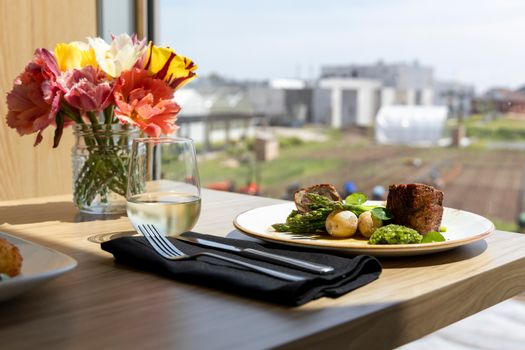Yellow and Red Flower on White Ceramic Plate Beside Stainless Steel Fork and Knife