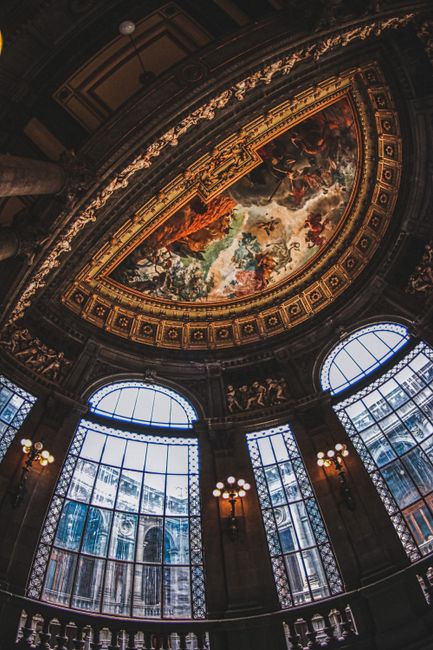 Stunning fresco and architectural detail in a classic Mexico City art museum ceiling.