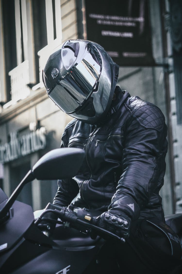 Close Up Of Man With Helmet On Motorcycle In A City