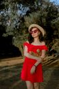 Woman in Red Dress Wearing Brown Sun Hat