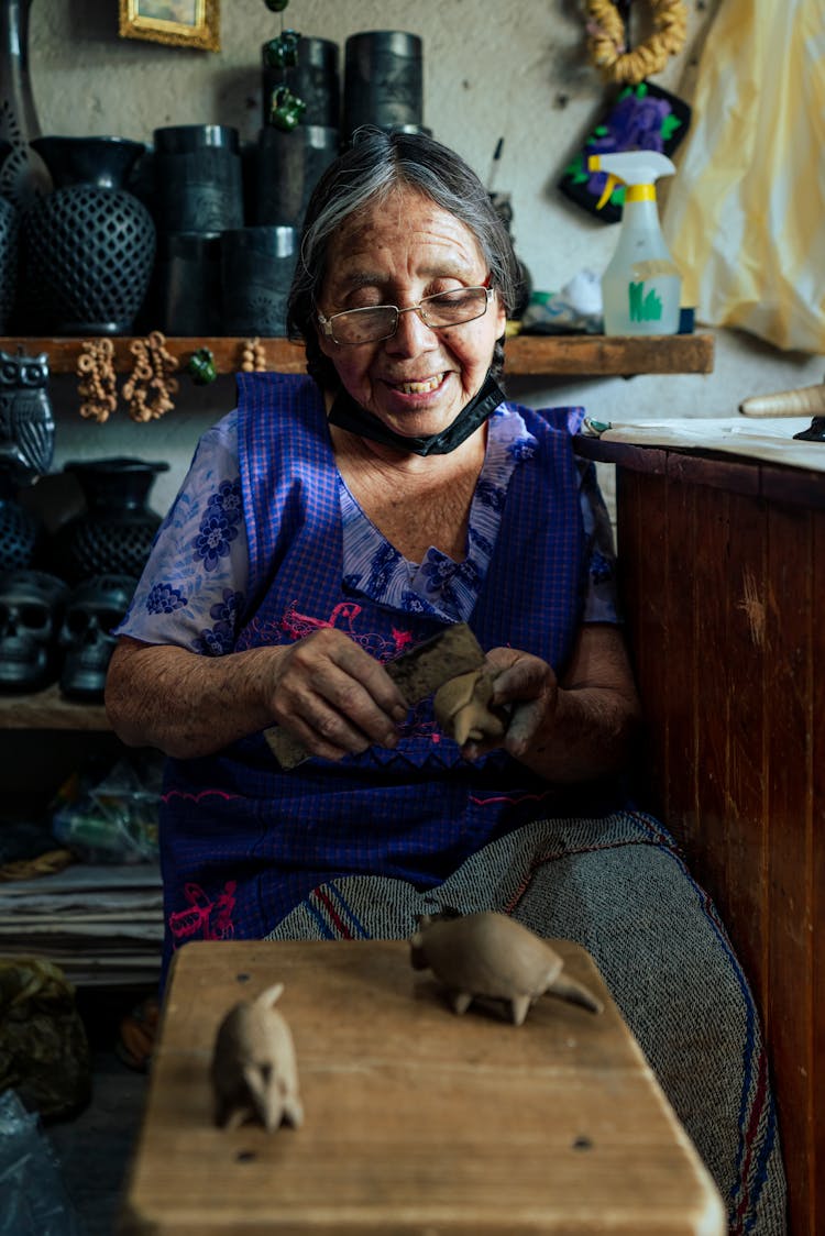 Woman Making Animal Figurines