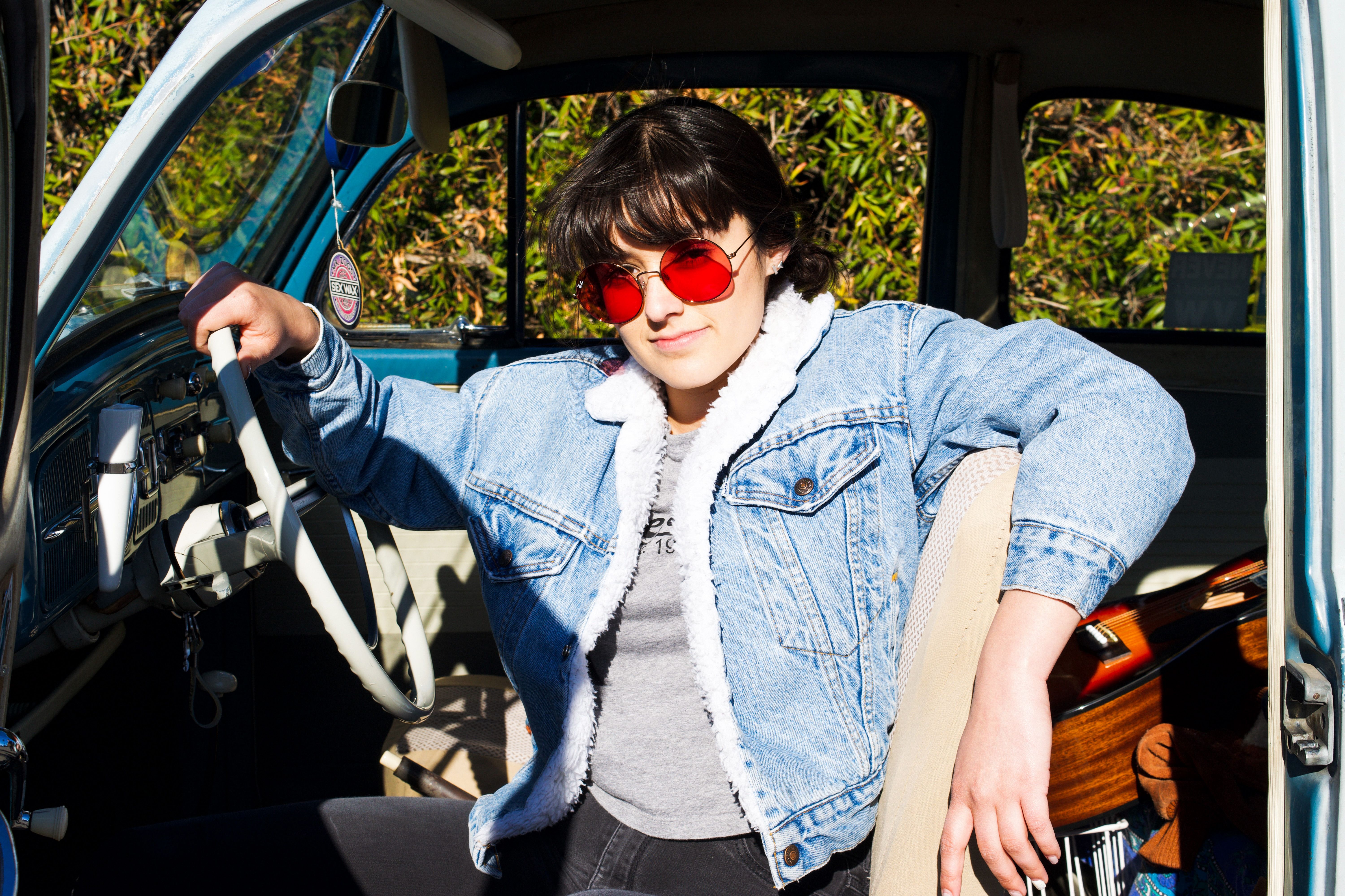 A Woman in Denim Jacket Sitting on Driver Seat · Free Stock Photo