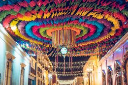 Colourful paper decorations strung above a festival street in Oaxaca — photo by Jhovani Morales on Pexels