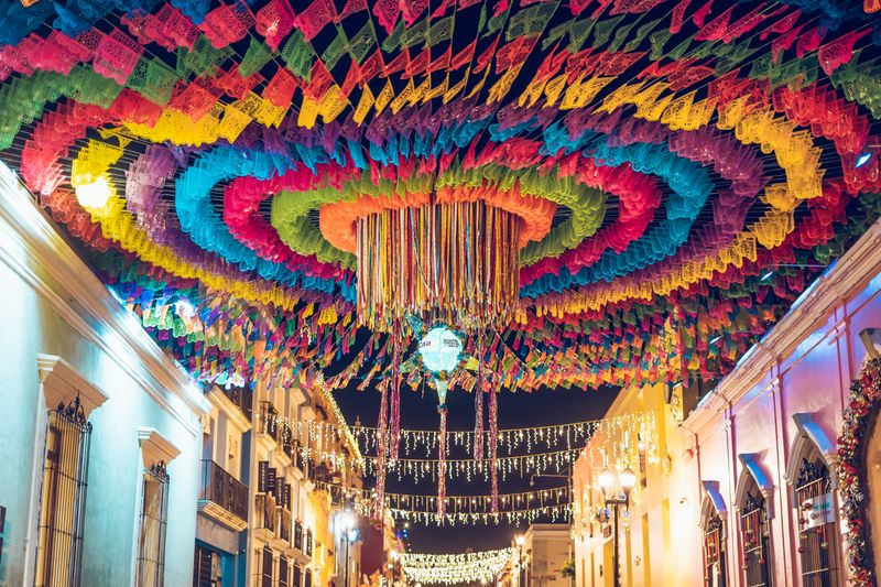 Colorful street decorations during a vibrant festival night in Oaxaca, Mexico