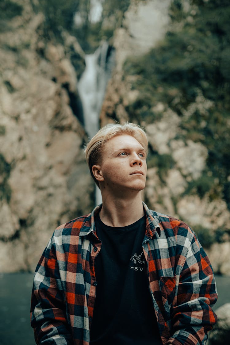 Portrait Of A Man In Checked Shirt With Rock In The Background