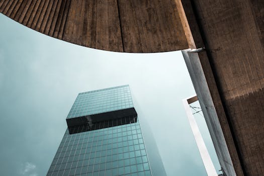 Person Sitting Inside Gray Framed Clear Glass Wall Building · Free 