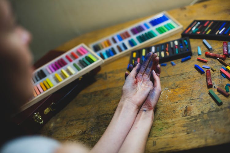 Girl With Hands Dirty From Crayons 