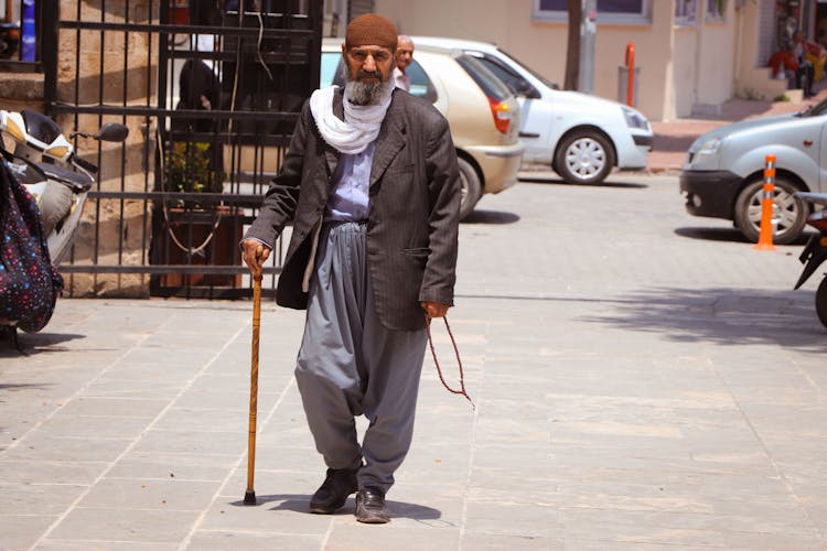 Bearded Man Walking With Cane