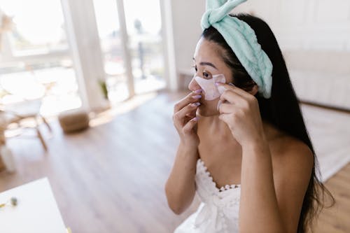 Woman while Doing Makeup on Face