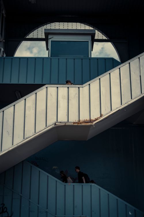 Free Modern urban staircase with people, showcasing geometric design and clean lines. Stock Photo