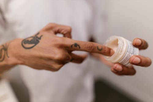 Free Close-up of Person Applying Cream from Bottle Stock Photo