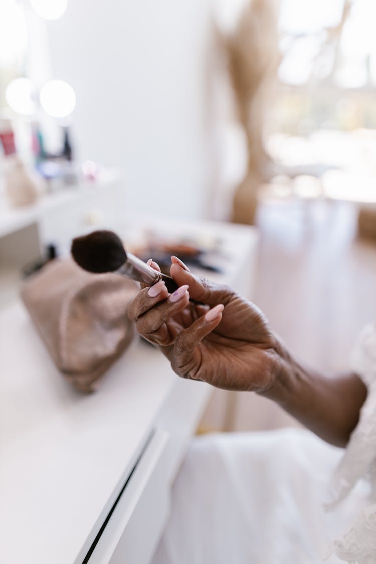 Woman Holding Makeup Brush