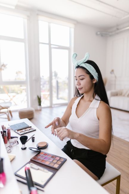 Asian woman applying skincare — bright clean routine