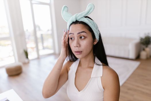 Woman with Hairband Touching Her Face