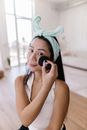 Woman in White Tank Top Wearing Teal Towel on Head