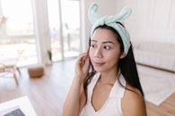 Woman in White Tank Top Wearing Teal Towel on Head