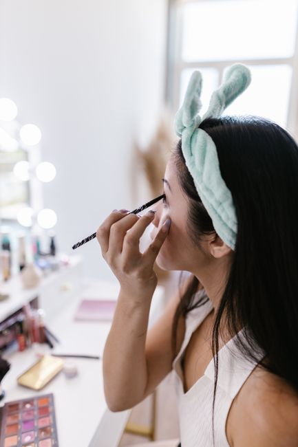 A woman using an eyebrow pencil during her morning beauty routine.