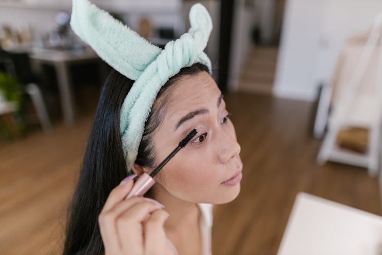 Young Woman Doing Makeup With Mascara