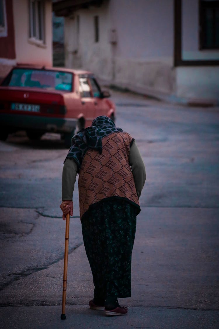 Elderly Woman Walking With A Cane