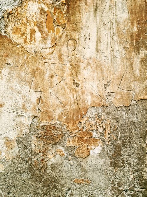 Free Close-up of a textured and aged wall surface in Rome, showcasing weathered and rough appearance. Stock Photo