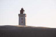Scenic view of Rubjerg Knude Lighthouse rising above the dunes in Løkken, Denmark.