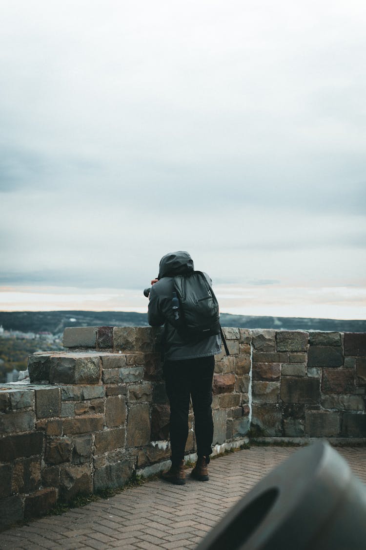 Man With Backpack Taking Pictures On Tower