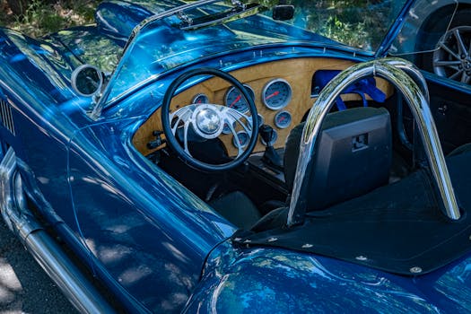 Explore the elegant interior of a blue vintage convertible, showcasing retro features and gauges.